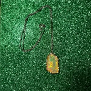 Yellow Faux Stone surrounded by gold tone rim